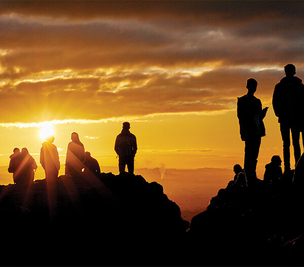 Group of people on top of a cliff
